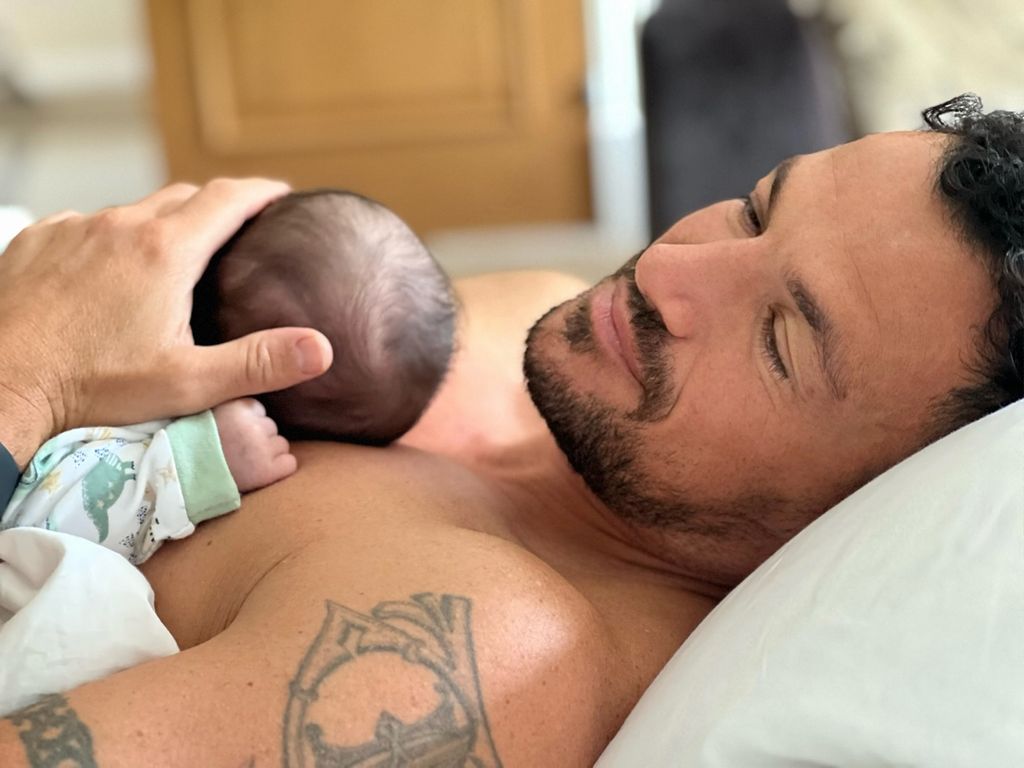 Peter Andre holding his daughter in his arms