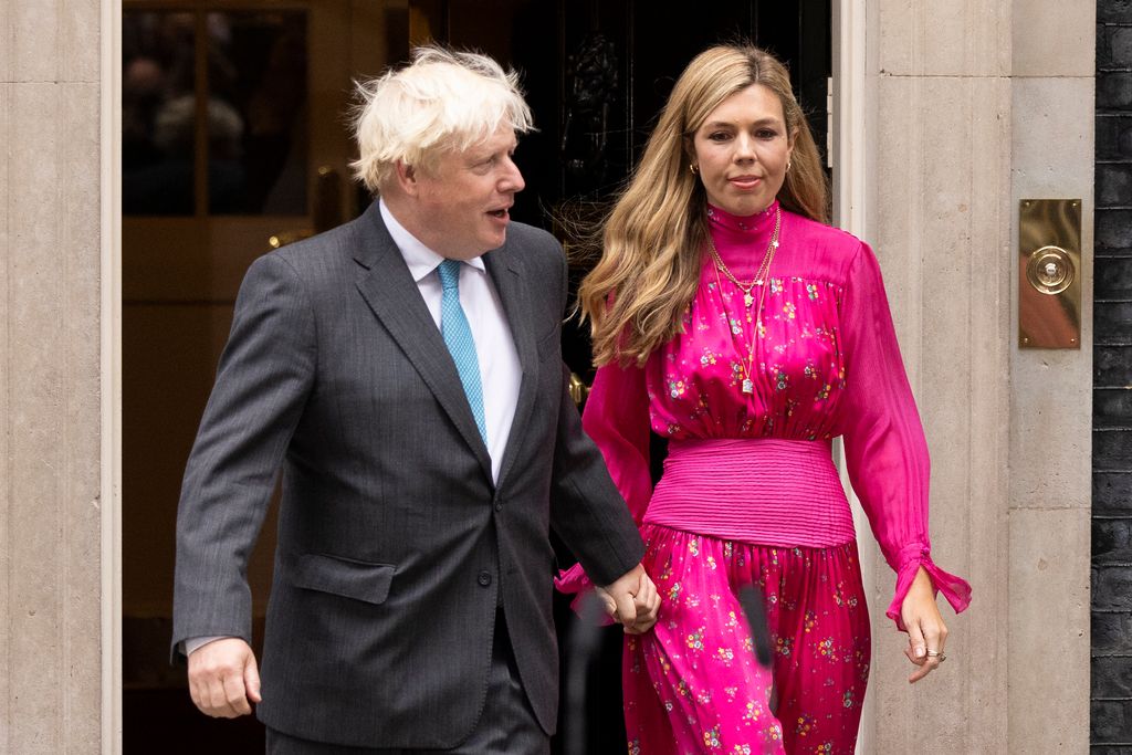 Former Prime Minister Boris Johnson and his wife Carrie Johnson on Downing Street. Carrie is wearing a pink dress. 