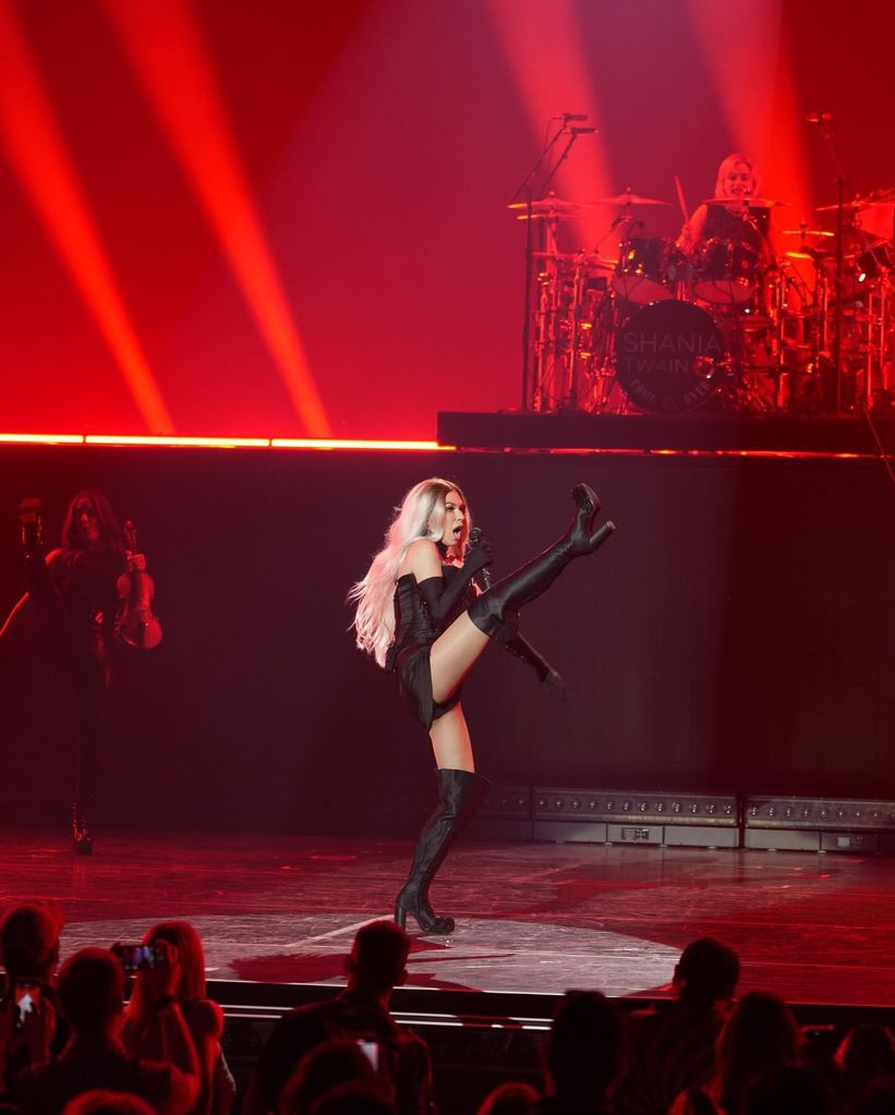 Shania Twain doing high kicks on stage