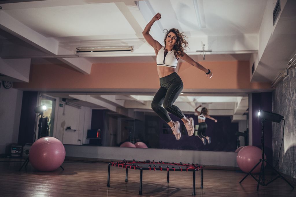 woman jumping on a mini trampoline
