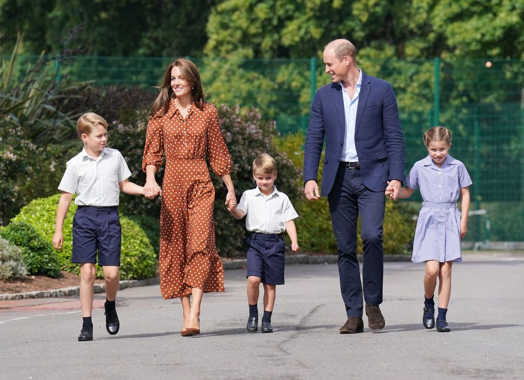 Prince George, Kate Middleton, Prince Louis, Prince William and Princess Charlotte walking to a school