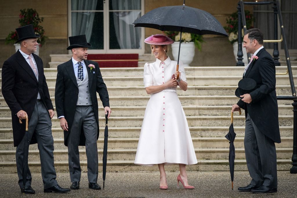 Zara Tindall looks like Mary Poppins under the umbrella at Buckingham Palace garden party