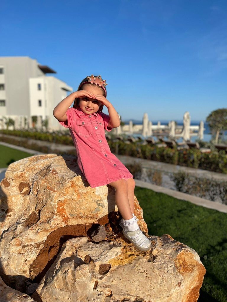 Ella Jordan, daughter of James Jordan, posing on a rock 