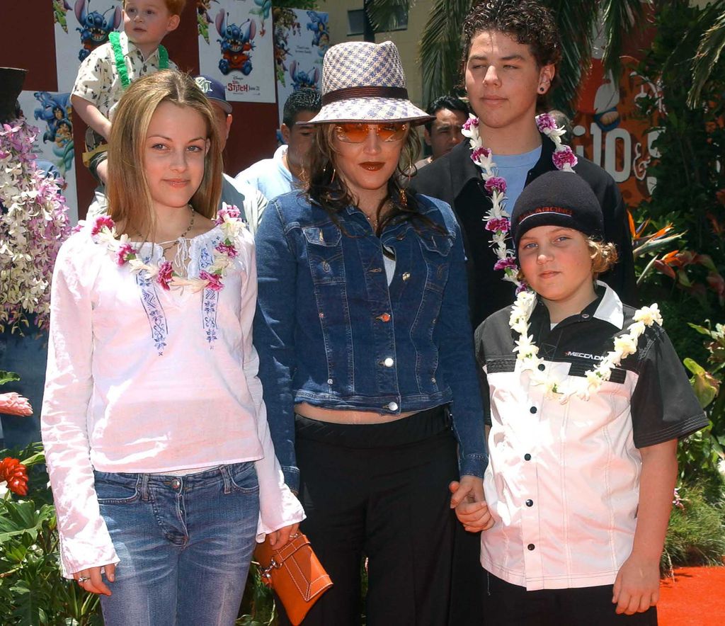 Lisa Marie Presley and her children Benjamin Keogh, Riley Keogh, and her half-brother Navarone Garibaldi (back) attended the premiere "Lilo and Stitch" June 16, 2002 at the El Capitan Theatre in Hollywood