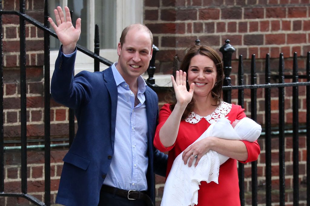 Prince William and Kate Middleton shake hands, Kate holds Prince Louis in her arms