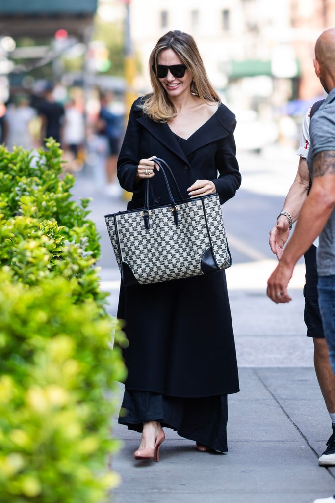 Angelina on the road in a black slip dress