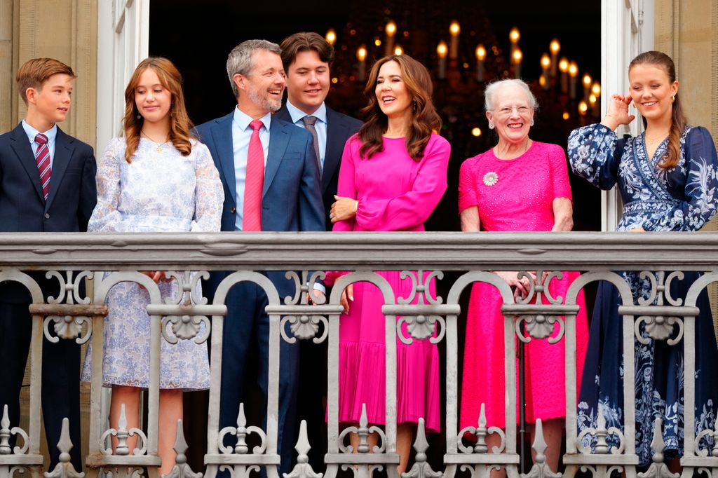 Prince Vincent, Princess Josephine, Crown Prince Christian, Queen Mary, Queen Margrethe, Princess Isabella and King Frederick X of Denmark react from the balcony on his 56th birthday at Frederick VIII's Palace