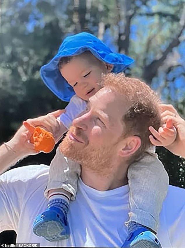 Archie is seen sitting on his father's shoulders in a photo revealed in Harry and Meghan's Netflix documentary
