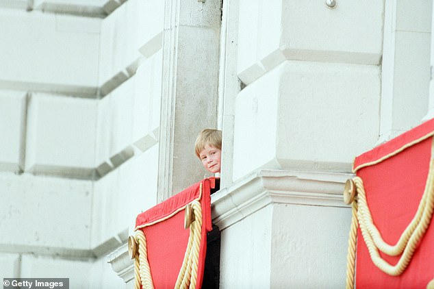 Prince Harry looks out a window at Buckingham Palace during Trooping the Colour in June 1990