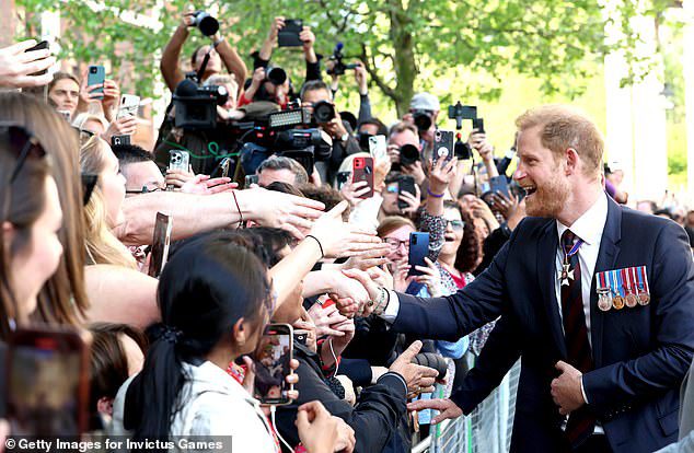 Prince Harry was ‘still anxious’ as he left St Paul’s Invictus service and ‘kept his distance from fans on walkabout in case his reception was less than warm’, body language expert says