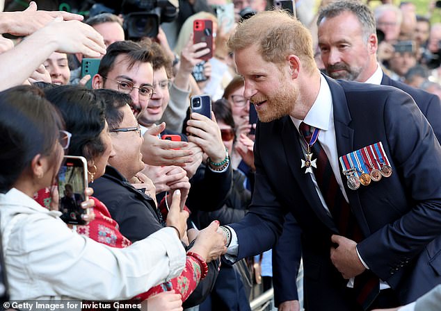 Prince Harry shook hands with fans waiting to meet him outside St Paul's yesterday