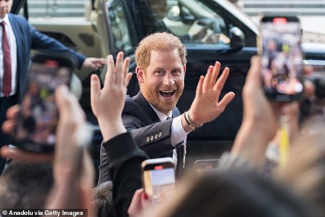 The Duke of Sussex waves to fans as he leaves after mass at St Paul's Cathedral yesterday