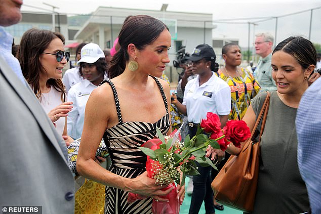 Meghan was spotted carrying flowers while watching a sitting volleyball match