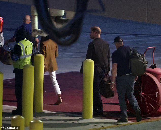 The couple seen earlier crossing the runway to get into a car to take them to the Los Angeles International Airport terminal