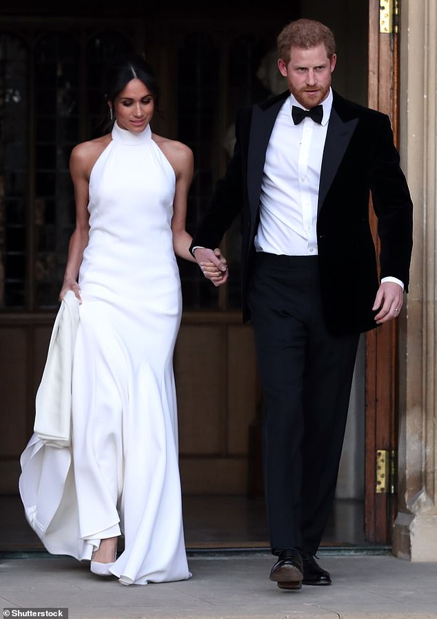 Meghan in her real wedding dress on the day of her wedding to Prince Harry in Windsor in 2018. Created by top designer Stella McCartney, it was worn for the less formal part of the day