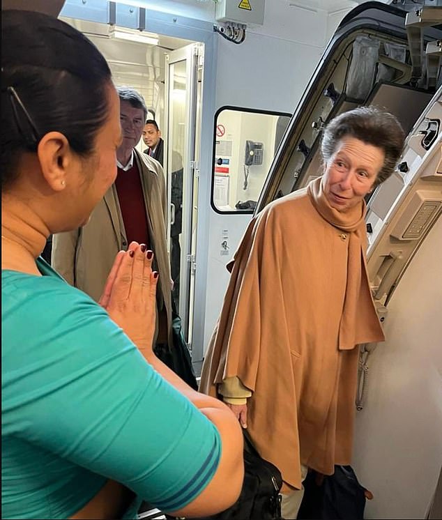 Princess Anne seen in January as she holds her own luggage while boarding a commercial flight to Sri Lanka
