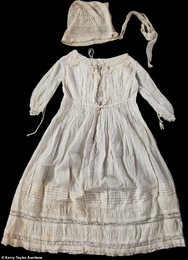 The white cotton baby dress and bonnet worn by Elizabeth will go on auction on June 11. It could fetch up to £1,200
