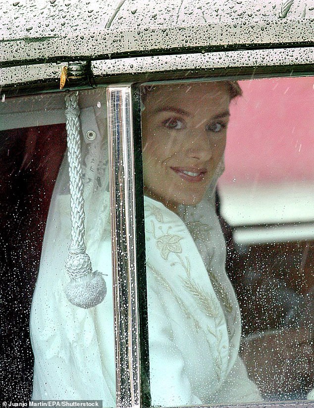 Letizia Ortiz Rocasolano smiles at the crowds of people as she approaches the Almudena Cathedral in Madrid on her wedding day, May 22, 2004.