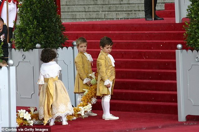 The young bridesmaids and page boys wore traditional Spanish attire in deep gold colors
