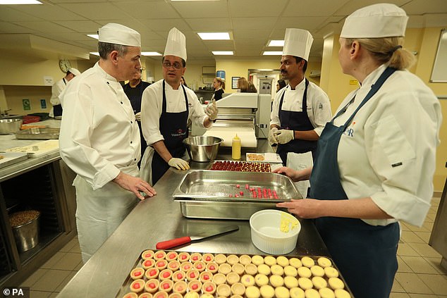 Buckingham Palace's Head Chef Mark Flanagan (left) is seen with other kitchen staff preparing for a reception to mark the launch of the UK-India Year of Culture 2017.