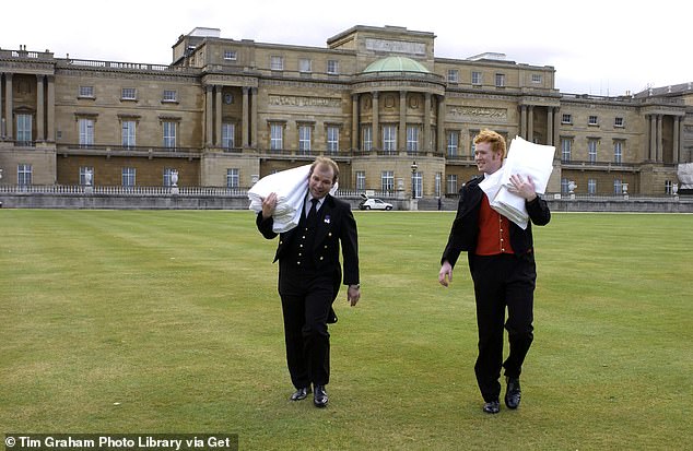 Palace staff carrying tablecloths to the royal tea tent in the garden of Buckingham Palace in 2001