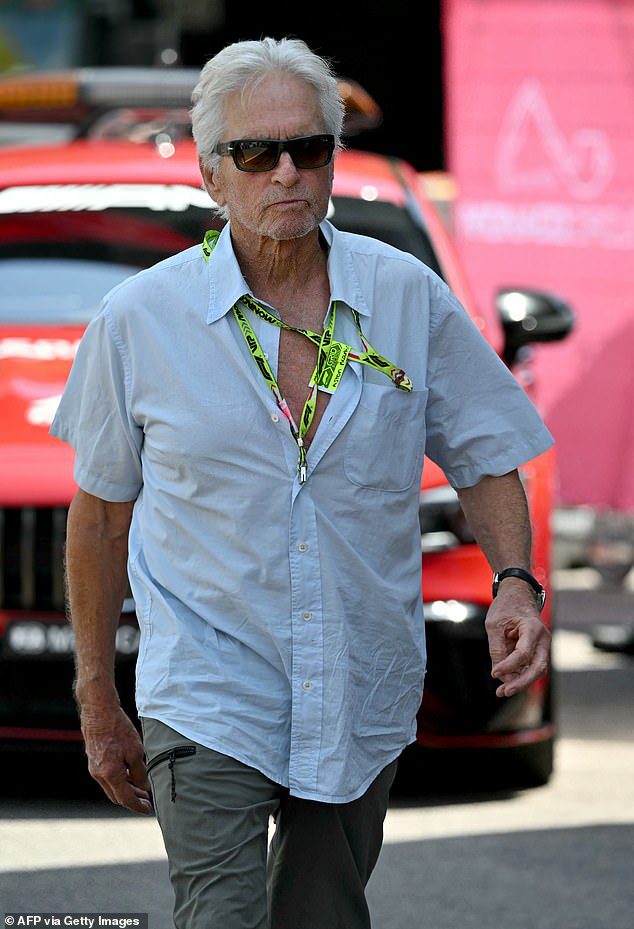 Michael Douglas, 79, keeps it casual in unbuttoned shirt and cargo pants as he takes over pit lane at star-studded F1 Grand Prix in Monaco