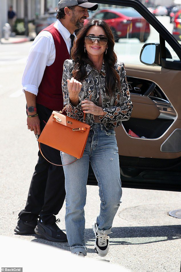 Kyle Richards models snakeskin jacket and jeans on lunch date with Morgan Wade… amid claims RHOBH producers ‘gave her an ultimatum’ to reveal true relationship with country star