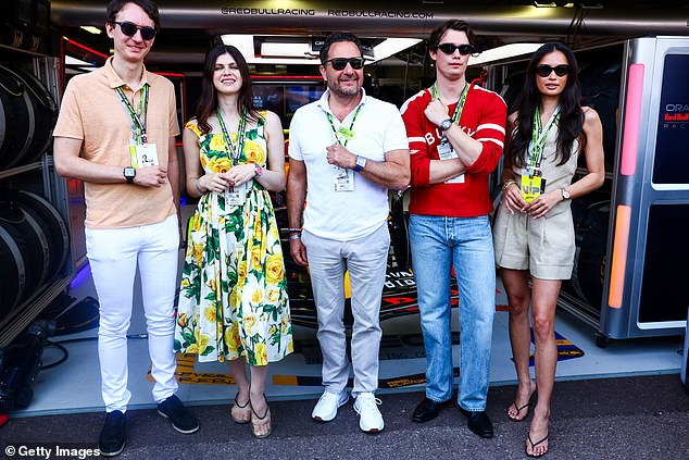 Frederic Arnault, Alexandra, Julien Tornere, Nicolas and Kelsey Oracle pose for a photo outside the Red Bull Racing garage