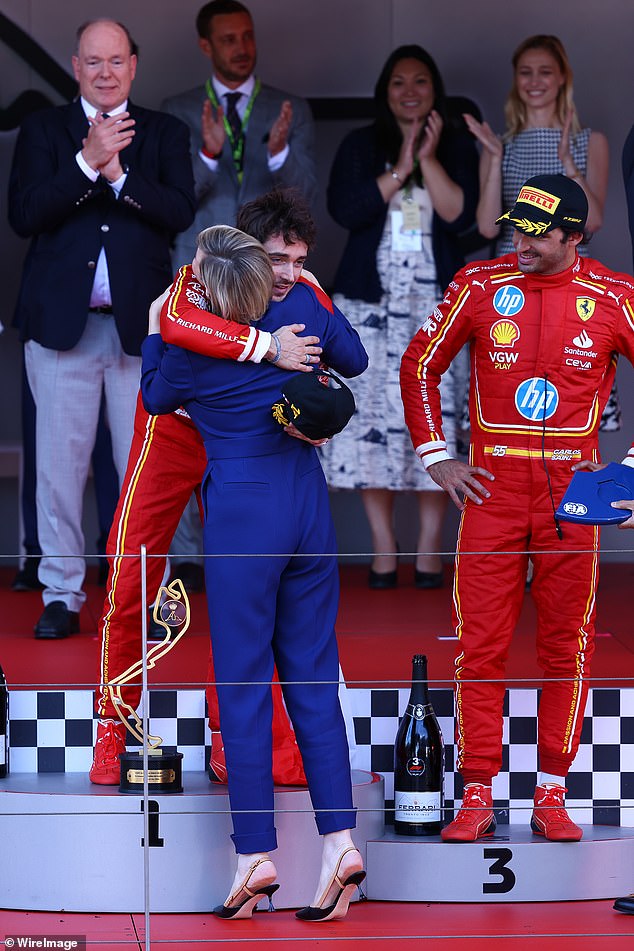 Princess Charlene stands on her tiptoes to embrace the winner of the Monaco Grand Prix, Charles Leclerc, who is from the principality and drives for Ferrari