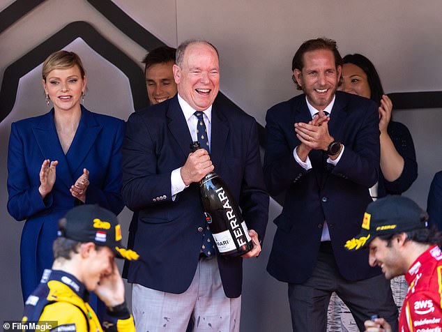 Prince Albert prepared to open a huge bottle of champagne to congratulate Leclerc