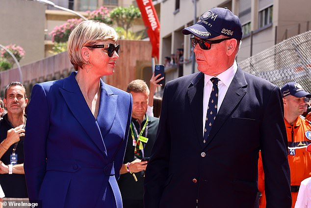 While Charlene made a statement in a double-breasted jumpsuit by Louis Vuitton, Prince Albert looked smart in a navy jacket and tie