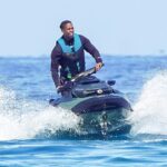 Travis Scott pictured jet-skiing with daughter Stormi, 6, in St. Tropez following Cannes, France melee with Tyga… as both musical artists formerly dated Kylie Jenner