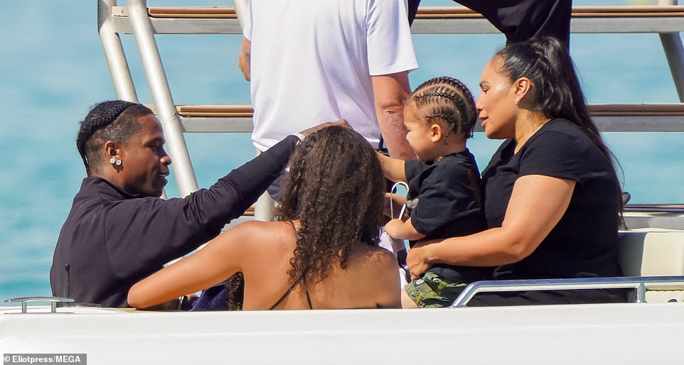 On the boat, the kids' nanny was seen holding Aire in her lap as Travis interacted with and entertained his son