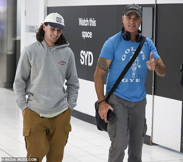 The Australian Idol favourite looked just as much like the Aussie rocker as they even gave each other a thumbs up as they passed through the airport.