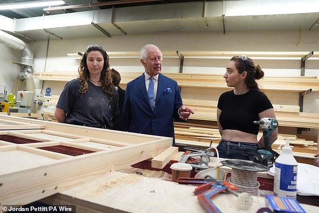 King Charles III speaks to students at the Scenic Art Studio during a visit to Rada today