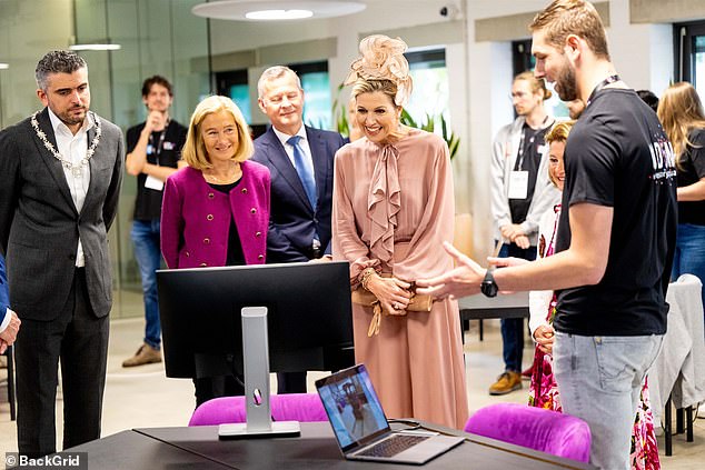 She smiled as she looked at a student's work on a computer screen, clearly impressed by what she was seeing