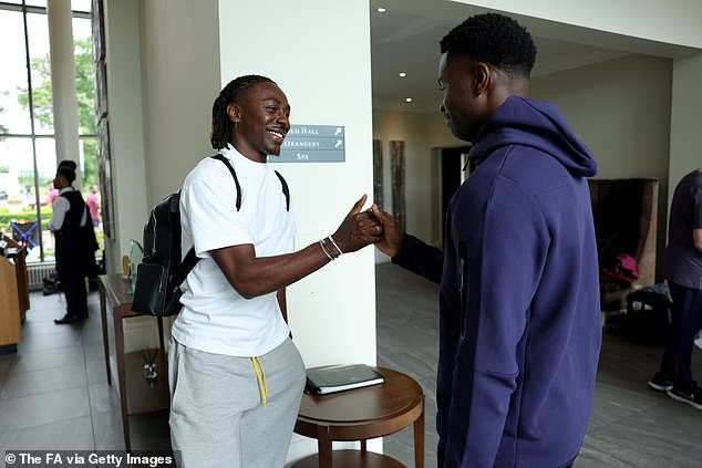 Crystal Palace midfielder Eberechi Eze gives an innocent look while chatting with Guehi
