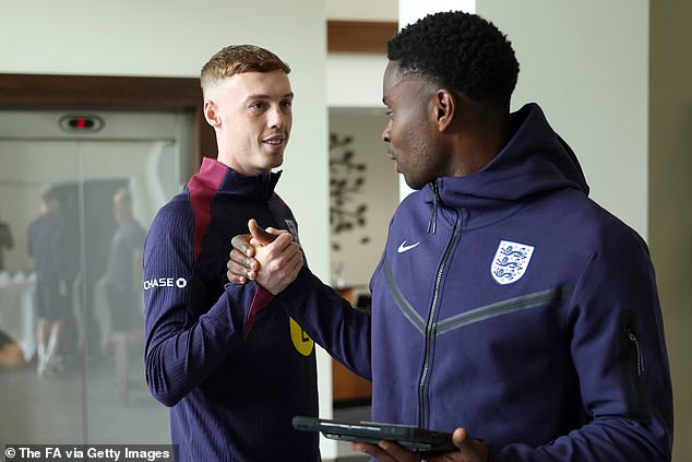 Cole Palmer (left) and Crystal Palace defender Marc Guehi (right) shake hands as they arrive at Rockliffe Hall