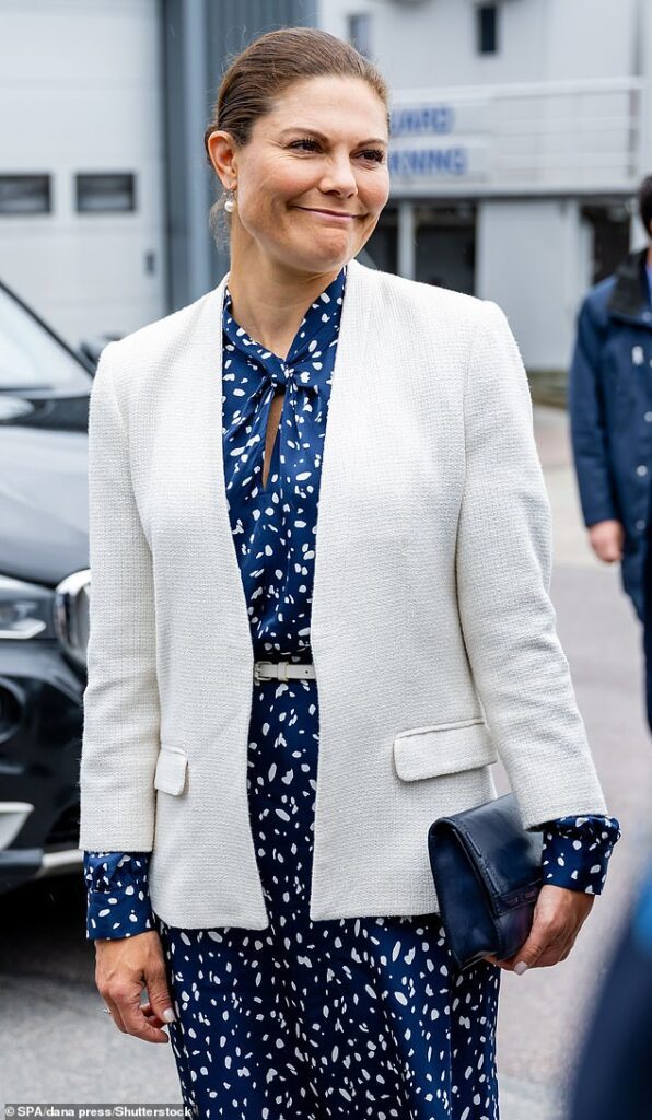 Crown Princess Victoria of Sweden sports nautical-themed polka dot dress as she visits a port in Gothenburg on Veterans Day