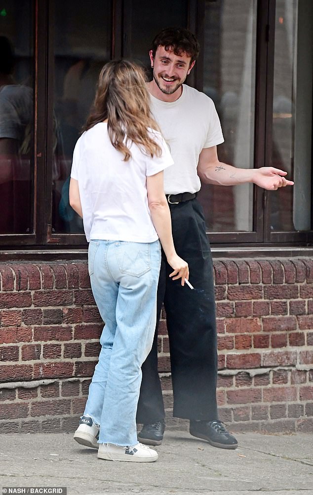 Paul opted for a low-key look in a white top paired with high-waist black trousers and Adidas Sambas