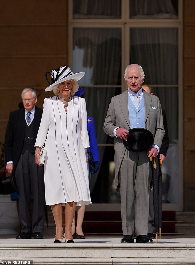 King Charles III and Queen Camilla, listen to the National Anthem ahead of the party