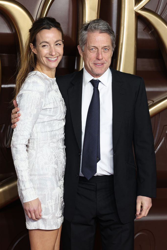 man in suit and woman in silver dress 