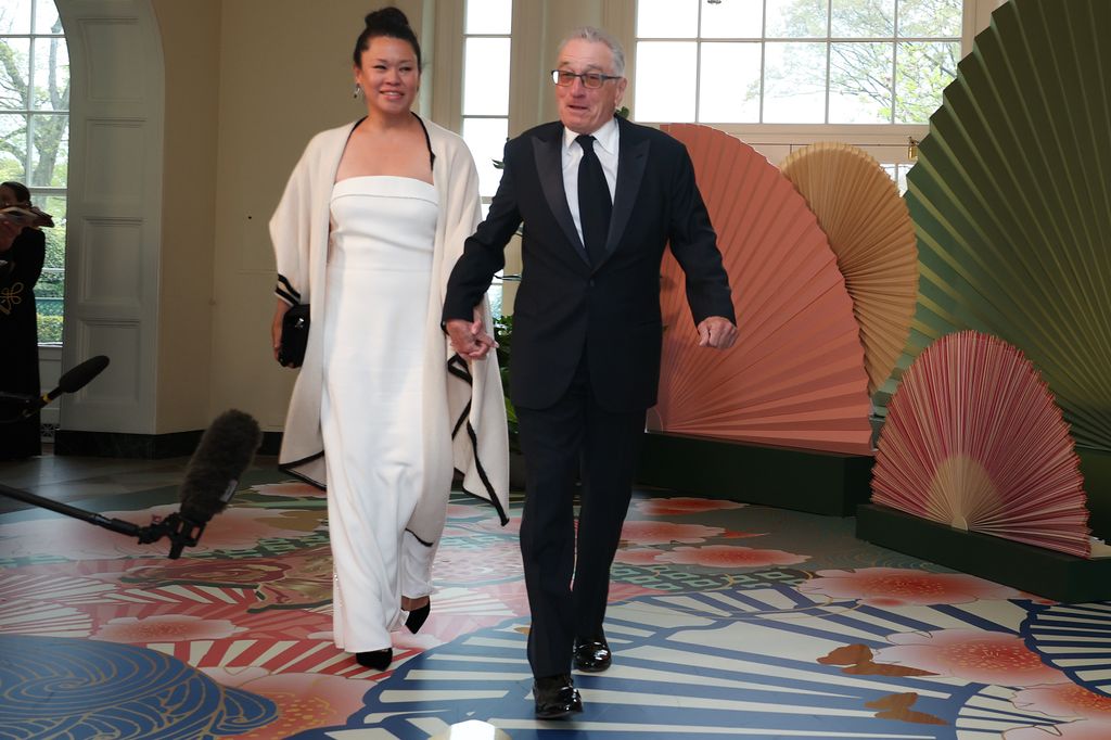 Robert De Niro (right) and Tiffany Chen arrive at the White House for a state dinner 