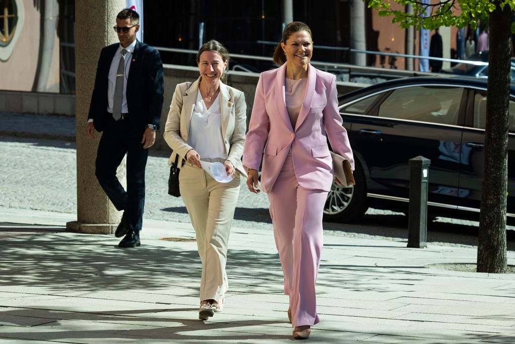 Crown Princess Victoria walks in a pink suit