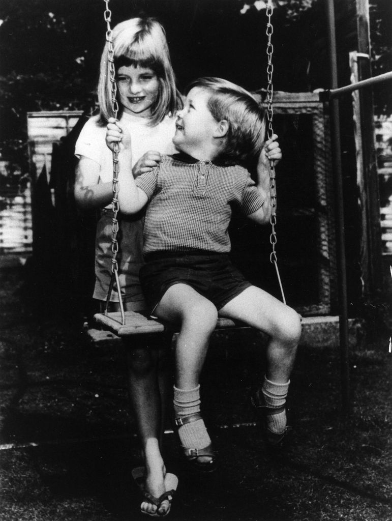 Young Princess Diana pushing her younger brother Charles Spencer on a swing
