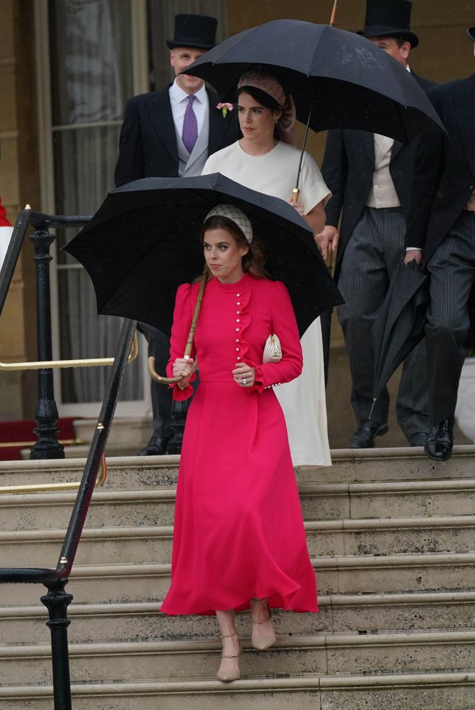 Princess Beatrice holding an umbrella in a bright pink dress