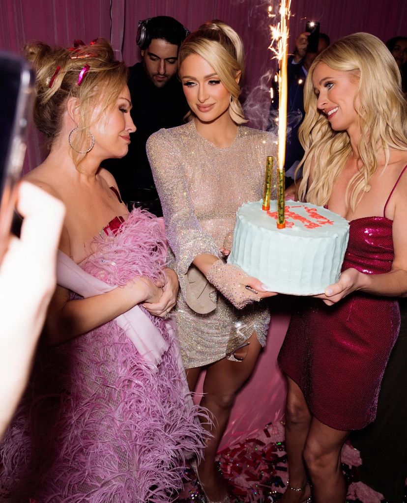 Kathy Hilton was presented with a cake by her daughters Paris and Nicky