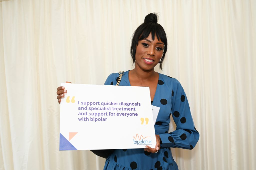 Leah Charles-King holds a Bipolar UK sign