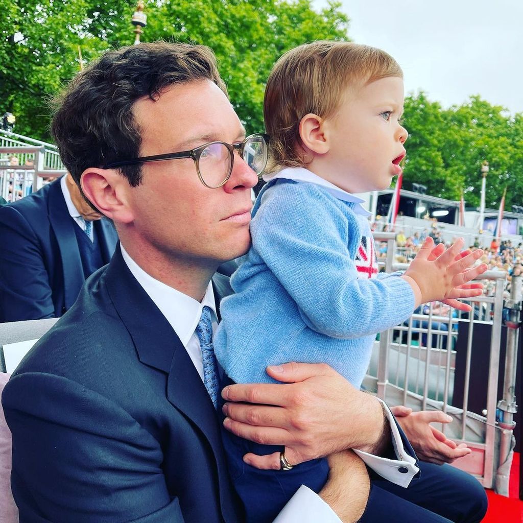 Jack Brooksbank holds August as he watches the coronation