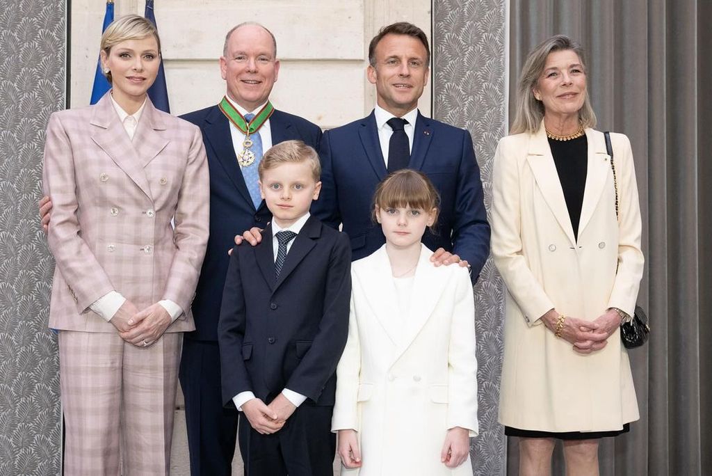 Princess Charlene wears a pink suit next to her husband Prince Albert, their children Jacques and Gabriella, and President Emmanuel Macron.
